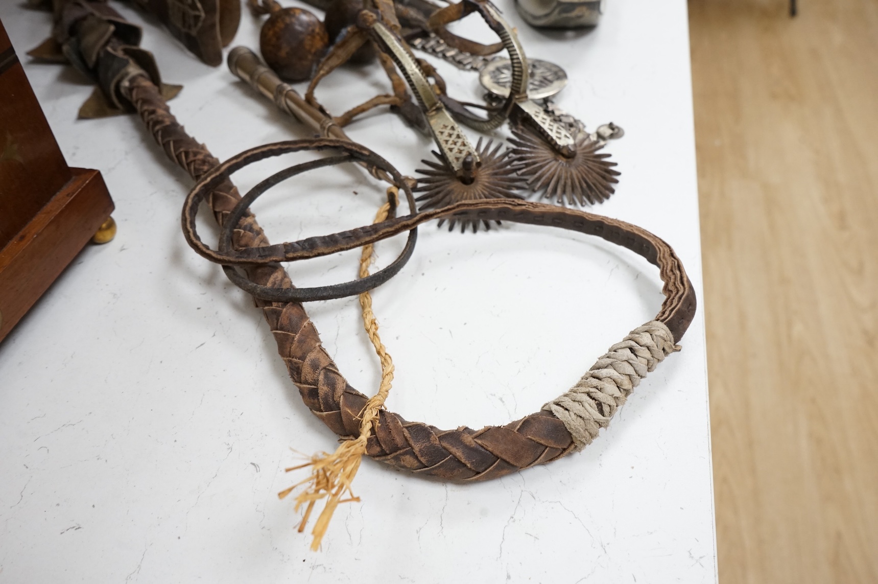 A group of Argentinian Gaucho spurs, bolas, bull whip, daggers and hanger, Longest 100cm